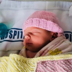 photo of a baby girl lying in crib