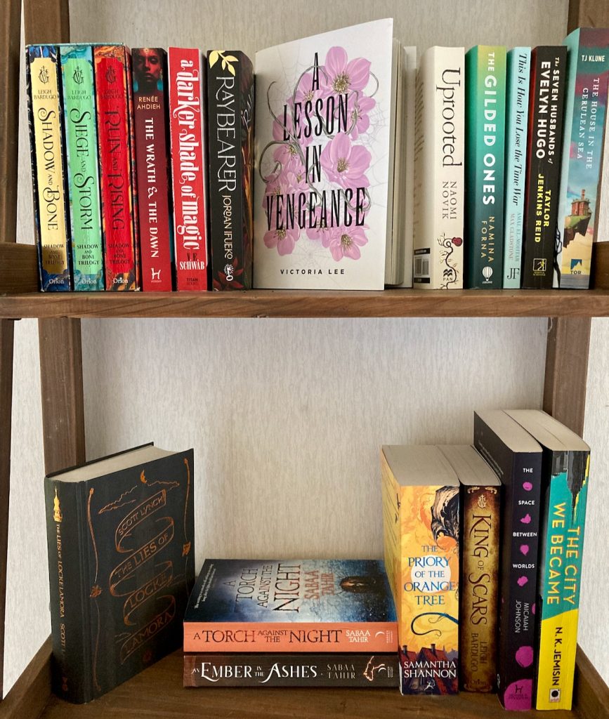 A selection of books on two wooden shelves